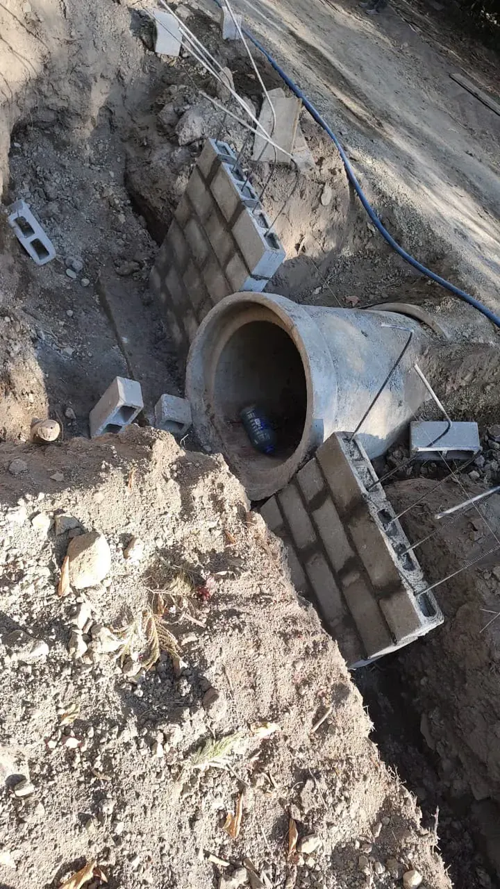 Concrete pipe and stone wall in fresh earthworks