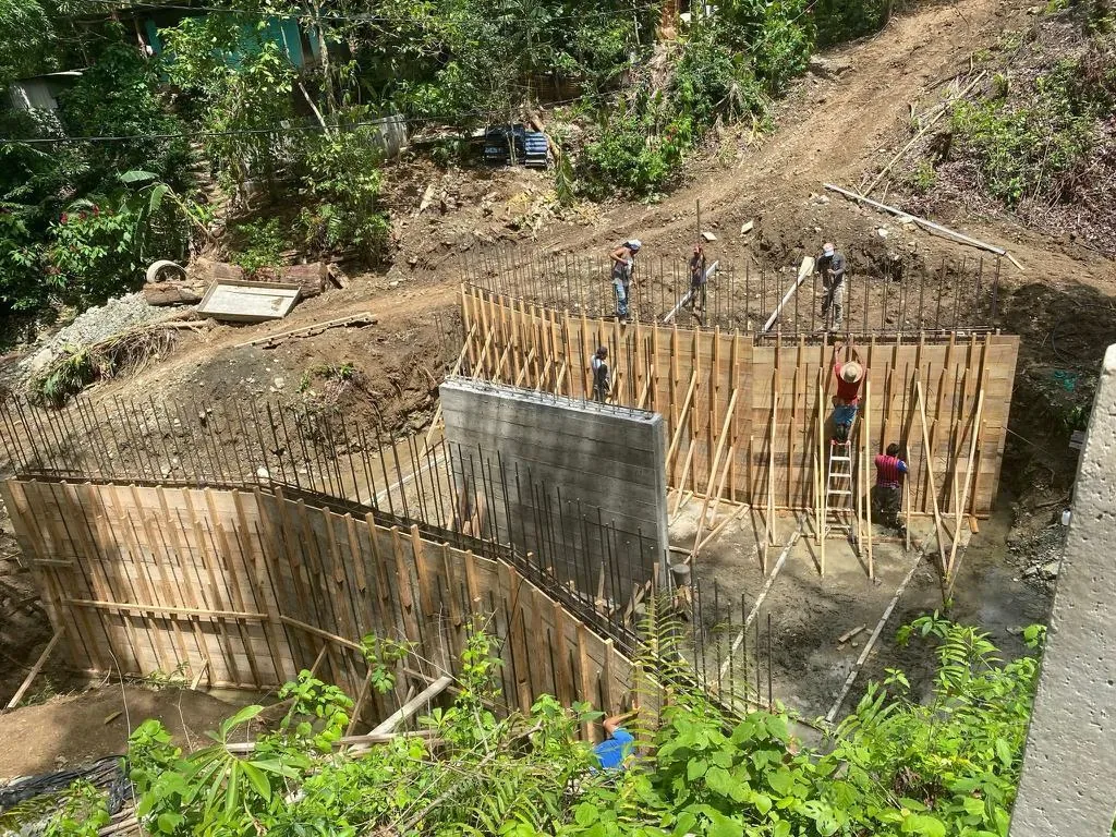 Workers and wooden formwork for the bridge abutments